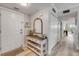 Entryway with coat closet, console table, mirror, and decorations at 420 Bouchelle Dr # 204, New Smyrna Beach, FL 32169