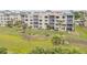 Condo building exterior on lush lawn with tropical palm tree accents at 420 Bouchelle Dr # 204, New Smyrna Beach, FL 32169