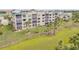 Condo building on lush lawn with tropical palm tree accents at 420 Bouchelle Dr # 204, New Smyrna Beach, FL 32169