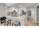 Modern kitchen featuring island sink with bar seating, white cabinets, and stainless steel appliances at 420 Bouchelle Dr # 204, New Smyrna Beach, FL 32169