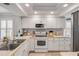 Well-appointed kitchen featuring white cabinetry, modern appliances, and ample counter space at 420 Bouchelle Dr # 204, New Smyrna Beach, FL 32169