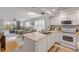 Open-concept kitchen with stainless appliances and white cabinetry, seamlessly connecting to the living area at 420 Bouchelle Dr # 204, New Smyrna Beach, FL 32169