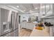 Modern kitchen with stainless steel appliances, white cabinets, and an open view towards the living spaces at 420 Bouchelle Dr # 204, New Smyrna Beach, FL 32169