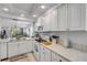 Well-lit kitchen with white cabinets, modern appliances, and an open view into the living area at 420 Bouchelle Dr # 204, New Smyrna Beach, FL 32169