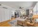 Bright living area features a plush sectional, access to a balcony, and a view into a bedroom, offering a comfortable design at 420 Bouchelle Dr # 204, New Smyrna Beach, FL 32169