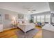 Serene main bedroom features white furniture, hardwood floors, and large windows, creating a tranquil and inviting space at 420 Bouchelle Dr # 204, New Smyrna Beach, FL 32169