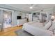 Airy main bedroom includes a sliding glass door to a balcony, white furniture, and wood floors, offering a serene retreat at 420 Bouchelle Dr # 204, New Smyrna Beach, FL 32169