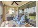 Cozy screened-in patio featuring comfortable seating and a tranquil outdoor view from sliding glass doors at 420 Bouchelle Dr # 204, New Smyrna Beach, FL 32169