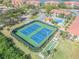 Aerial view of the community's tennis courts next to the pool and clubhouse, offering residents recreation and socializing at 420 Bouchelle Dr # 204, New Smyrna Beach, FL 32169
