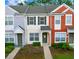 Charming townhome featuring a colorful exterior, well-manicured landscaping, and a welcoming entrance at 4412 Sw 49Th Ave, Ocala, FL 34474