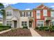 Charming townhome featuring a colorful exterior, well-manicured landscaping, and a welcoming entrance at 4412 Sw 49Th Ave, Ocala, FL 34474