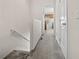 Hallway with neutral carpet leads to bedrooms and a full bath at 4412 Sw 49Th Ave, Ocala, FL 34474