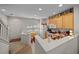 Bright kitchen area featuring white appliances and view of an eat-in area with natural light at 4412 Sw 49Th Ave, Ocala, FL 34474