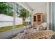 Screened patio with outdoor seating area, including wicker chairs at 4412 Sw 49Th Ave, Ocala, FL 34474