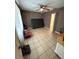 A secondary bedroom boasts tile flooring and a ceiling fan for comfortable temperatures at 5549 Nw 64Th St, Ocala, FL 34482