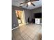 Bedroom featuring tile flooring, ceiling fan and adjacent bathroom provides comfortable living at 5549 Nw 64Th St, Ocala, FL 34482