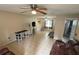 Spacious living room with tile flooring, ceiling fan, and plenty of natural light at 5549 Nw 64Th St, Ocala, FL 34482