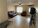 Bright living room with tile flooring, ceiling fan, and natural light at 5549 Nw 64Th St, Ocala, FL 34482