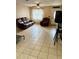 Bright living room with tile flooring, ceiling fan, and natural light at 5549 Nw 64Th St, Ocala, FL 34482