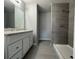 Modern bathroom featuring a spacious vanity, granite countertops, and tiled walk-in shower at 5787 Nw 58Th Ter, Ocala, FL 34482