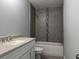This bathroom offers a tub and shower combo with contemporary tile surround and a modern vanity at 5787 Nw 58Th Ter, Ocala, FL 34482