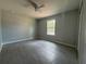 Large bedroom with gray tile floors, ceiling fan, and a window offering natural light at 5787 Nw 58Th Ter, Ocala, FL 34482