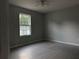 Cozy bedroom with a large window providing natural light and tiled floors at 5787 Nw 58Th Ter, Ocala, FL 34482
