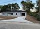 Exterior view of a home with a new driveway and attached garage in a quiet setting at 5787 Nw 58Th Ter, Ocala, FL 34482