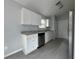 Modern kitchen features white cabinets, stainless steel appliances, and granite countertops at 5787 Nw 58Th Ter, Ocala, FL 34482