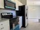 Modern kitchen featuring stainless steel appliances, granite countertops, and ample cabinet space for storage at 5787 Nw 58Th Ter, Ocala, FL 34482
