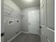Functional laundry room with wire rack shelving and tile flooring offers practicality and style at 5787 Nw 58Th Ter, Ocala, FL 34482