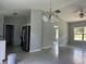 Open-concept living area with ample natural light, modern light fixture, and easy access to kitchen and other rooms at 5787 Nw 58Th Ter, Ocala, FL 34482