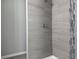 Modern shower features elegant tile work, sleek fixtures, and a spa-like ambiance for a luxurious experience at 5787 Nw 58Th Ter, Ocala, FL 34482