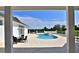 An outdoor pool and spa with a clear blue sky and landscaping create a serene backyard at 601 Se 80Th St, Ocala, FL 34480