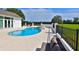 This backyard has a spa, pool, black fence, lounge chairs and meticulously maintained landscaping at 601 Se 80Th St, Ocala, FL 34480