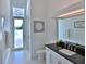 Light-filled bathroom leading to pool area has white cabinets and modern fixtures at 601 Se 80Th St, Ocala, FL 34480