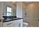 This bathroom features a glass shower, white vanity, and black countertop at 601 Se 80Th St, Ocala, FL 34480