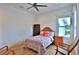 Bright bedroom with wood floors, ceiling fan, and colorful bedding at 601 Se 80Th St, Ocala, FL 34480
