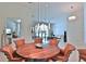 Cozy dining room with modern chandelier and beautiful view into the kitchen and living spaces at 601 Se 80Th St, Ocala, FL 34480