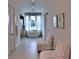 Hallway leading to a bathroom with a soaking tub, luxurious chairs, and windows at 601 Se 80Th St, Ocala, FL 34480