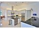 Modern kitchen with stainless steel appliances, granite countertops and a large island at 601 Se 80Th St, Ocala, FL 34480