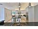 Modern kitchen features stainless steel appliances and island with black granite countertops at 601 Se 80Th St, Ocala, FL 34480