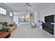 Bright living room view into kitchen with fireplace and sleek ceiling fans at 601 Se 80Th St, Ocala, FL 34480