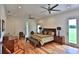 The main bedroom features wood floors, neutral colors, and ceiling fans at 601 Se 80Th St, Ocala, FL 34480