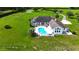 A beautiful in-ground pool and patio area grace the rear of this home with lush green grass at 601 Se 80Th St, Ocala, FL 34480