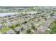 An aerial view captures the layout of the suburban homes, green lawns, and the serene lake in this residential area at 6651 Sw 93Rd Ct, Ocala, FL 34481