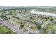 An aerial view shows a quiet residential neighborhood with mature trees and a scenic lake in the background at 6651 Sw 93Rd Ct, Ocala, FL 34481