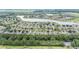 Aerial view of the community with lake, golf course, and tree lined streets in a well maintained neighborhood at 6651 Sw 93Rd Ct, Ocala, FL 34481