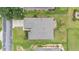 Bird's-eye view of a property displaying roof details, surrounding greenery, and overall lot layout at 6651 Sw 93Rd Ct, Ocala, FL 34481