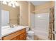 Bathroom features a white vanity, toilet, and a shower/tub combo with curtain at 6651 Sw 93Rd Ct, Ocala, FL 34481